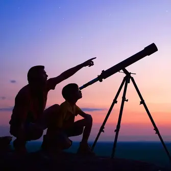 Adult and child using a telescope