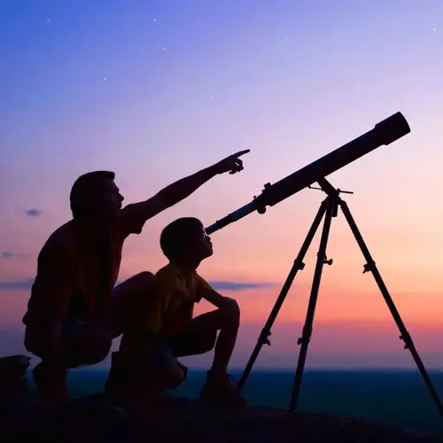 Adult and child using a telescope