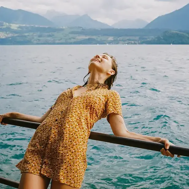 smiling woman leaning over a railing
